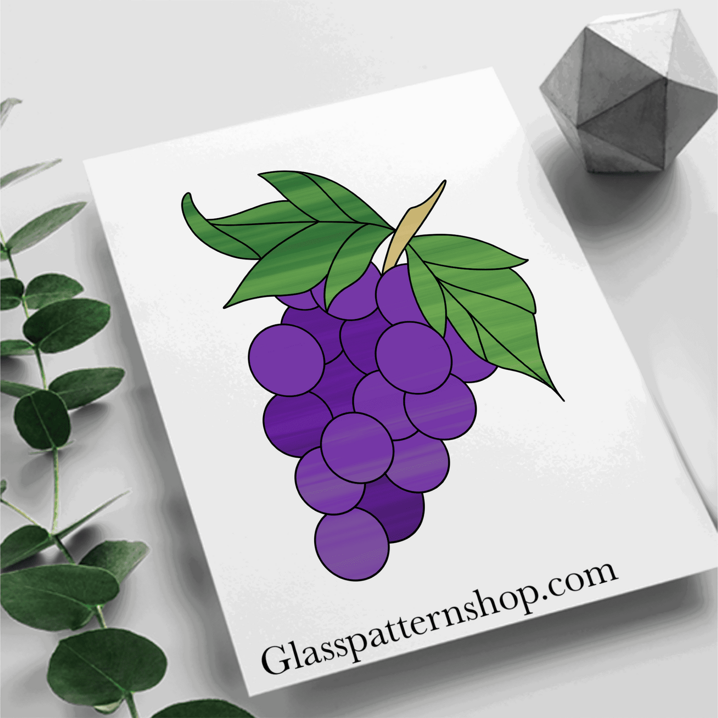 A stained glass pattern featuring a cluster of grapes with leaves and vines, designed for versatile and customisable stained glass projects.