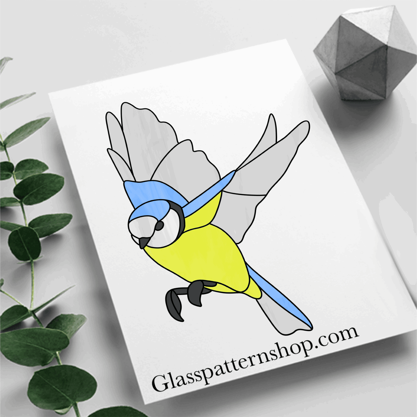 A detailed stained glass pattern of a Blue Tit perched in flight, perfect for suncatchers and window panels.