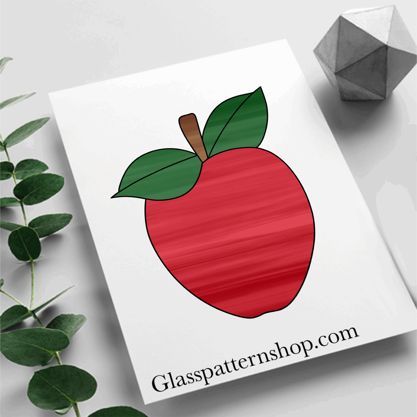 A printable apple stained glass pattern featuring a classic apple shape with a leaf, designed for easy customization with various glass colors and textures.