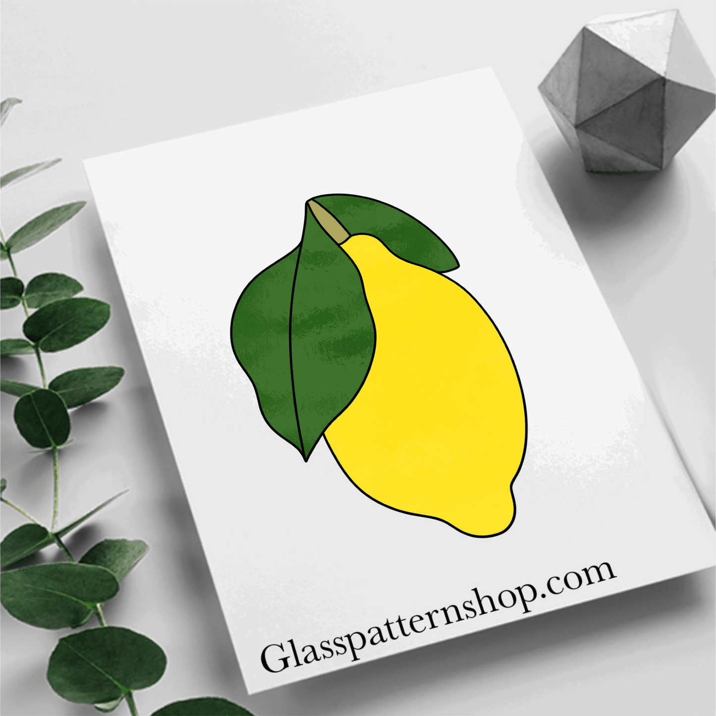 A stained glass pattern featuring a lemon with detailed leaves, designed for customisable and vibrant stained glass projects.