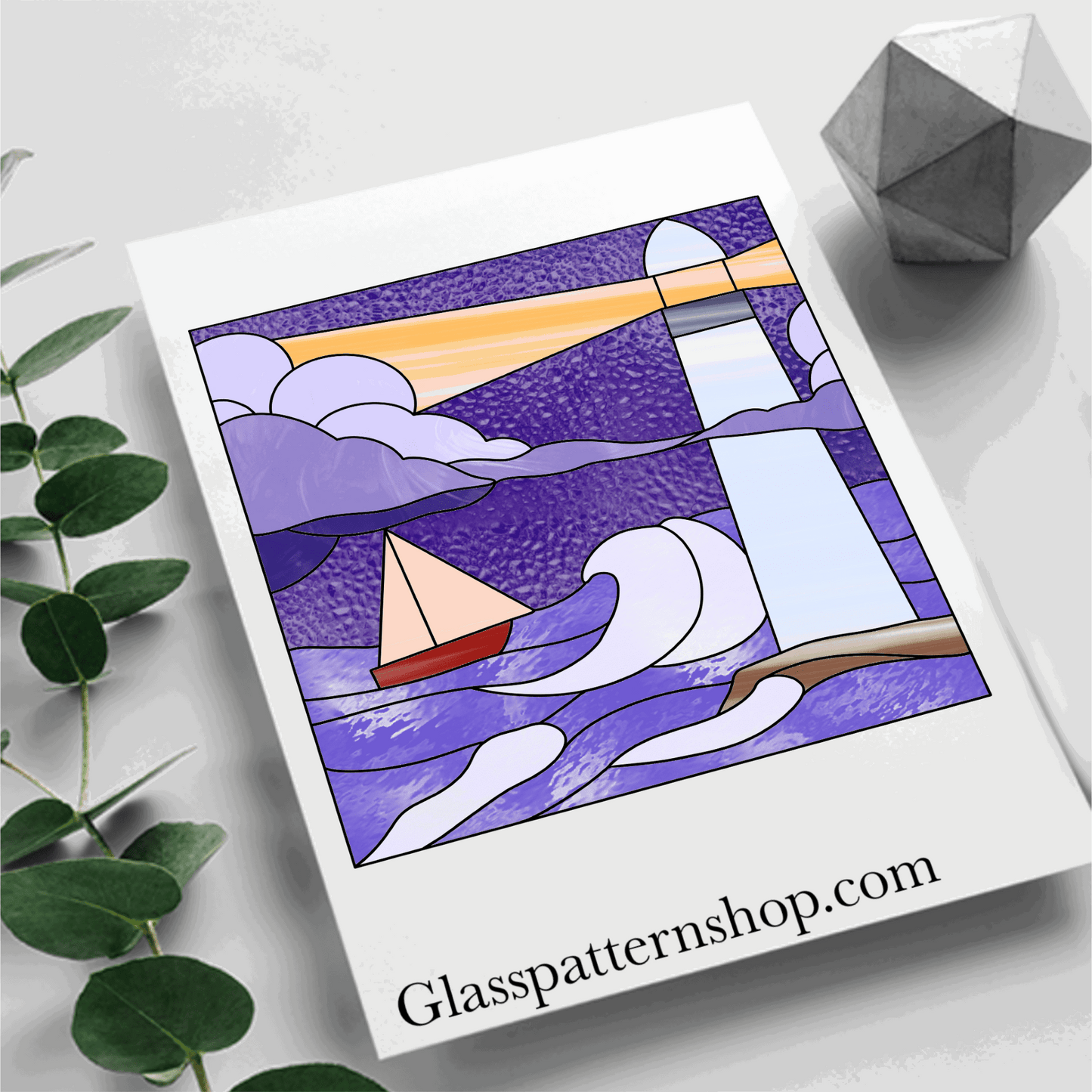 Detailed stained glass pattern of a lighthouse by the sea