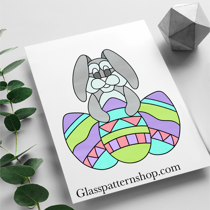 Cute Bunny Stained Glass Pattern – A digital stained glass outline of a cute bunny sitting with three decorated Easter eggs.