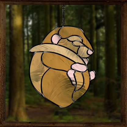 Stained glass pattern featuring a dormouse curled up among leaves. Perfect for creating woodland-themed glass art.