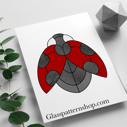 Stained glass pattern featuring a detailed ladybird resting on a leaf. Perfect for creating vibrant, nature-themed glass art.