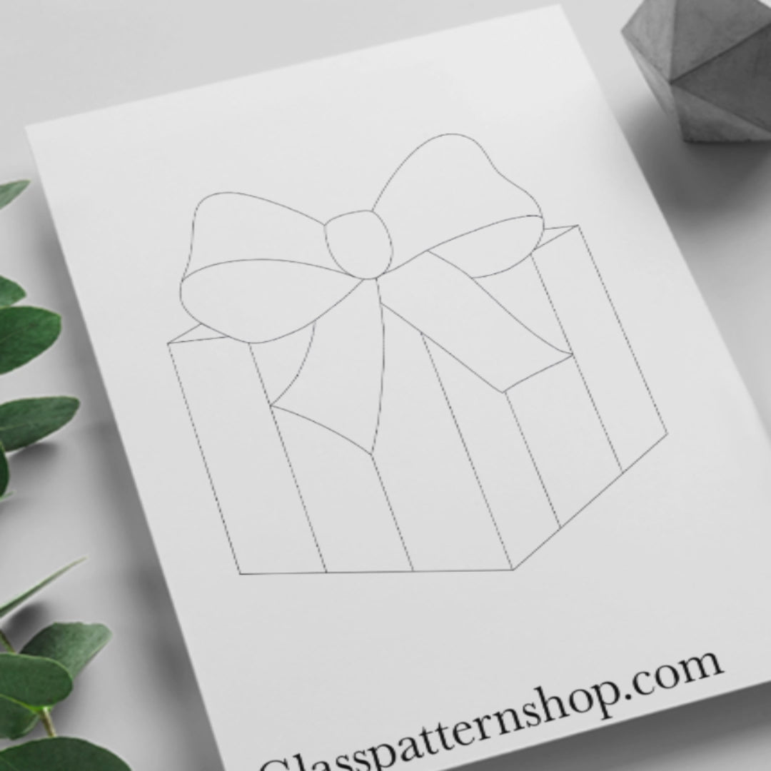 Digital stained glass pattern featuring a colorful gift box tied with a bow, ideal for festive or holiday-themed designs.