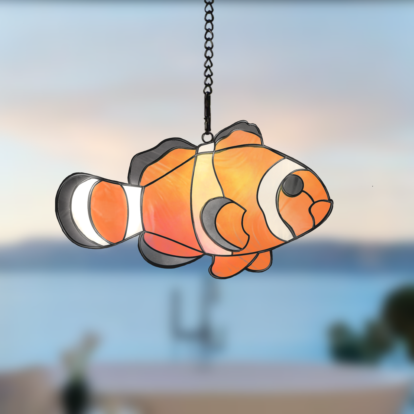 Tropical clown fish stained glass pattern, colorful ocean-themed glass design.